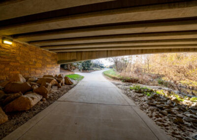 A concrete walking and jogging trail under a bridge in North Carolina