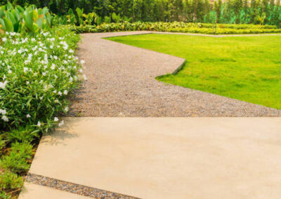 Garden landscape design with a mixed concrete and stone aggregate pathway