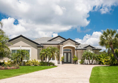 A luxury home in South Carolina with a large concrete driveway and walkway paths