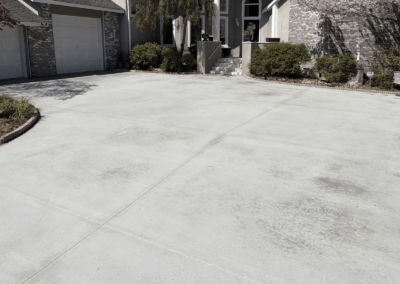New concrete driveway at a grey brick home in South Carolina