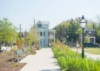 A classic south carolina colonial neighborhood with a park and concrete sidewalk