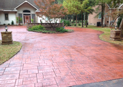 stamped red colored concrete driveway